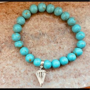 Turquoise beaded stretch bracelet with caged charm